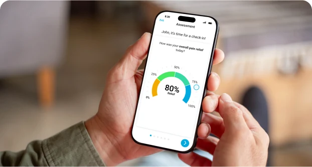 Hands holding a smartphone that shows an HFX App check-in screen with a pain relief dial